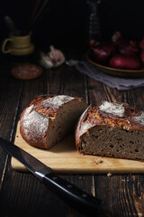 A loaf of rye bread in low key	