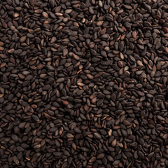 Black Sesame Seeds, for the production of oil, or for sprinkling flour products and as a condiment. Background, texture. top view