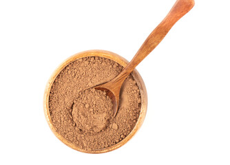 Top view of a wooden bowl with cocoa powder and a wooden spoon.