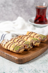 Chocolate, pistachio and coconut cookies on gray background. Bakery cookies assortment. Cookies with a cup of tea. vertical view. Close up