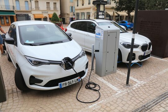 BEZIERS, FRANCE - OCTOBER 3, 2021: Renault Zoe and BMW electric car connected to charging station in Beziers, Occitanie region of France.