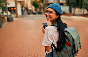 Asian female tourist student on city streets - obrazy, fototapety, plakaty