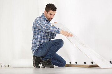 working with hands installs a laminate board