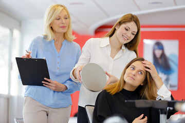 women hairdressers standing in hair and beauty salon