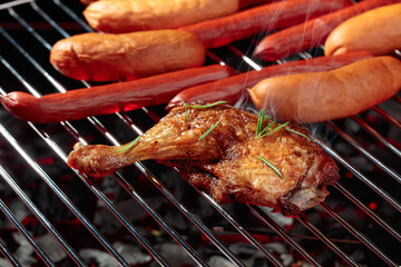 Chicken and sausages on a grill.