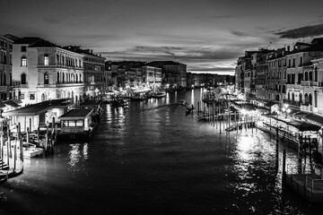 Naklejka premium Evening cityscape in Venice, Italy; Sunset over Grand Canal from Rialto Bridge in black and white