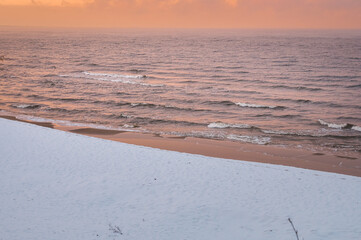 Frosty winter morning at Baltic sea shore in Riga. Beautiful landscape of seaside covered in snow and ice.