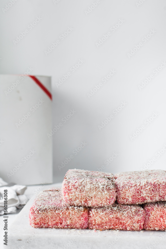 Canvas Prints Pink lamingtons on a marble tray, Australian raspberry lamingtons, cake covered in desiccated coconuts