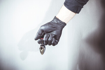 sexy man holds a BDSM anal plug in his hands.