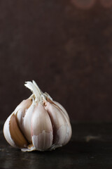 Garlic bulbs on dark wood table, garlic,unpeeled raw garlic, Allium sativum