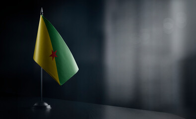 Small national flag of the French Guiana on a black background