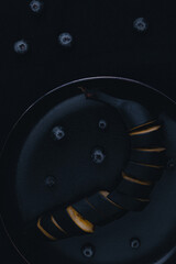 black banana with blueberries on a dark background