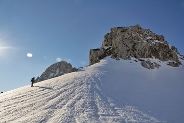 Fototapeta na wymiar girl climbs a snowy slope on snowshoes to reach the top of Pico Aguja, Asturias.