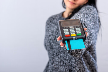 caucasian woman holding payment terminal and giving it to the customer can pay with credit card