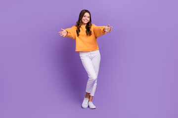 Full length photo of sweet friendly girl dressed orange sweatshirt open arms ready hug you isolated purple color background