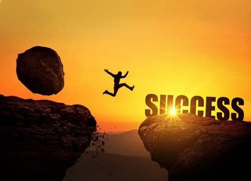 Businessman runs from a falling stone on a mountain and jumps over a cliff at sunset. Success, finance and business. Creative idea for success. Rockfall and danger