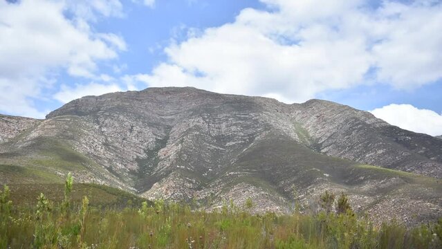 a hyperlaps of clouds moving over the cloetesberg mountain range in the little karoo semi desert area of the western cape province of south africa 