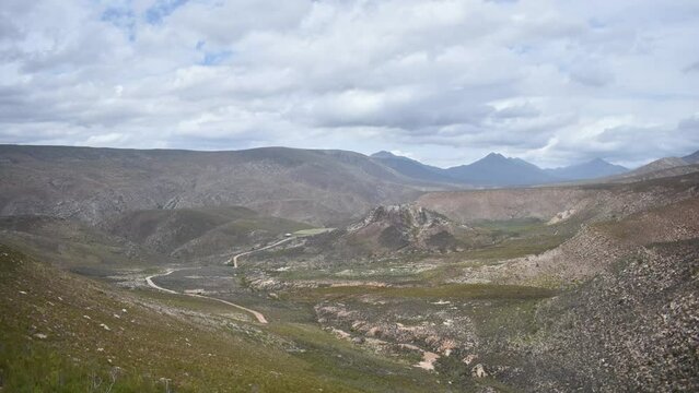 a hyperlaps of clouds moving over the cloetesberg mountain range in the little karoo semi desert area of the western cape province of south africa 