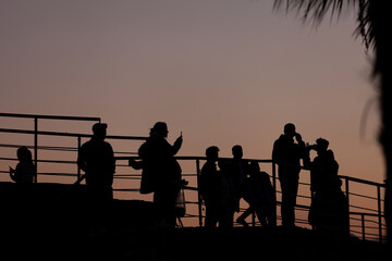 Fototapeta na wymiar people taking pictures at sunset selfie silhouette valentine's day