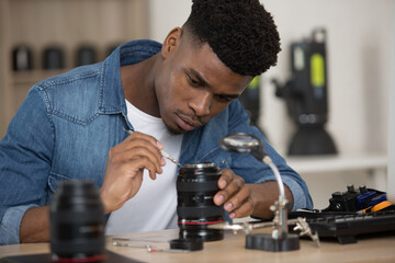 young man during the disassembled lens mount slr camera