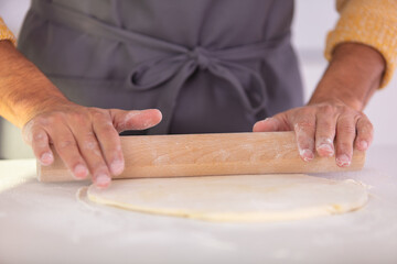 closeup image of man with rolling pin making tart
