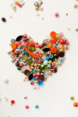 Frame in the shape of hearts. Background of multicolored decorative craft beads. Valentine's Day. Symbol of love.
