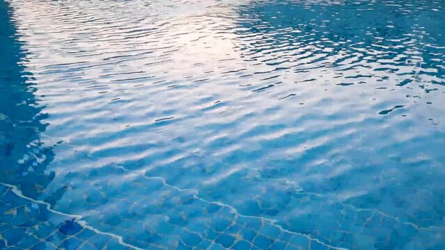 Slow motion footage of the ripples on the pool surface. Activities