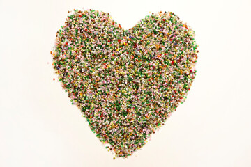Frame in the shape of hearts. Background of multicolored decorative craft beads. Valentine's Day. Symbol of love.
