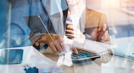 Businessman and team analyzing financial statement Finance task. with smart phone and laptop and...