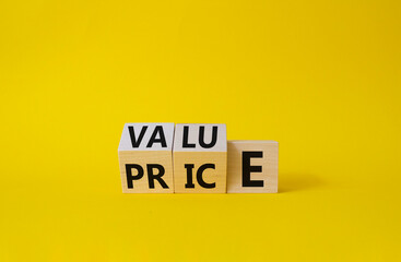 Value and Price symbol. Wooden cubes with words Price and Value. Beautiful yellow background....