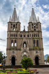 Fototapeta na wymiar Brick cathedral (basilica) of Jardin (Jardín) with a dramatic morning sky. Antioquia, Colombia.