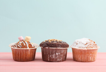 Appetizing cupcakes on a pastel background