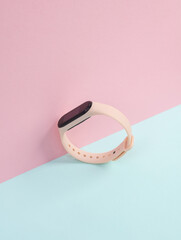 Creative layout of a modern smart bracelet on a pastel background
