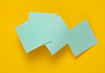 Blue memo papers on a yellow background
