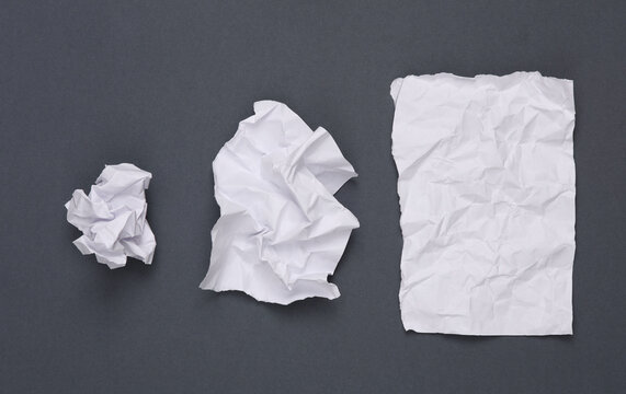 Step by step process of crumpling paper into a ball on gray background