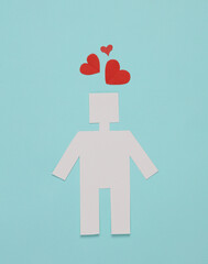 Paper cut robot with hearts on a blue background