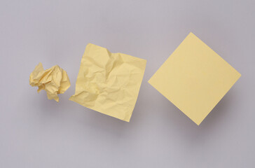 Step by step process of crumpling paper into a ball on gray background