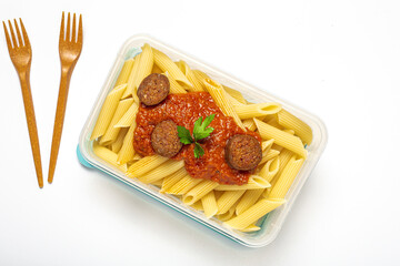 Macaroni with tomato sauce, chorizo and cheese in plastic container