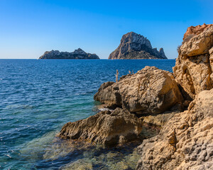 Fototapeta na wymiar Panoramic views of the island of Es Vedra and Vedranell, located on the coast of the island of Ibiza. In front of the Cala d'Hort beach, one of the most visited by tourists.