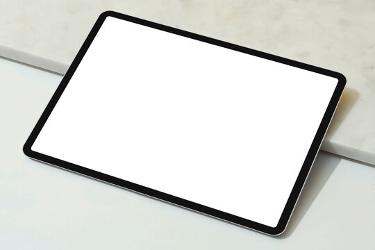 Modern digital tablet pc with blank white screen isolated on white floor background