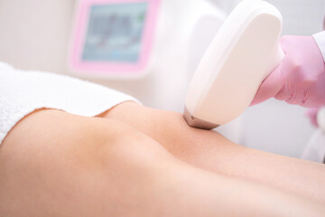 Diode laser hair removal, Beautician removes hair on beautiful female legs, Hair removal for smooth...