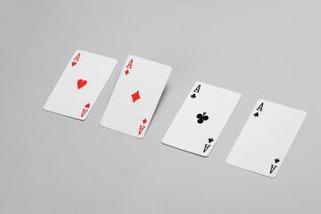 Four aces on a gray background
