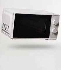 Wireless microwave oven levitating on white background with shadow