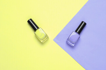 Bottles of nail polish on pastel background. Beauty layout