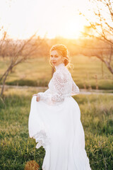 Fine art portrait of a bride at sunset. The concept of a wedding for two in nature.