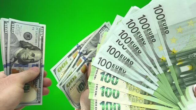 Several bills on one hundred holding dollars Top view of businesswoman's hands counting one hundred dollar banknotes on colorful background. Success and wealth concept Dollars to change to euros