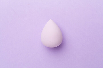 Beauty blender on color background, top view