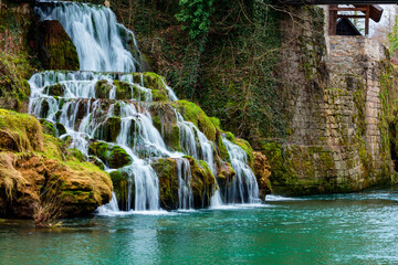 Fototapeta na wymiar Stunning green colored river makes even prettier waterfall, spring time in Croatia, Europe