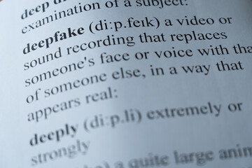 A mock up of a dictionary page with the word deepfake with selective focussing