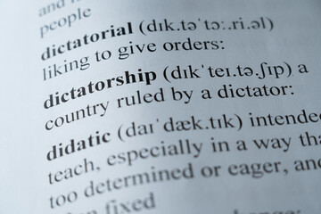 A mock up of a dictionary page with the word dictatorship with selective focussing